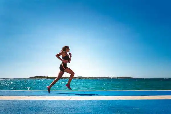 Woman running showing strong leg muscle Woburn Sands